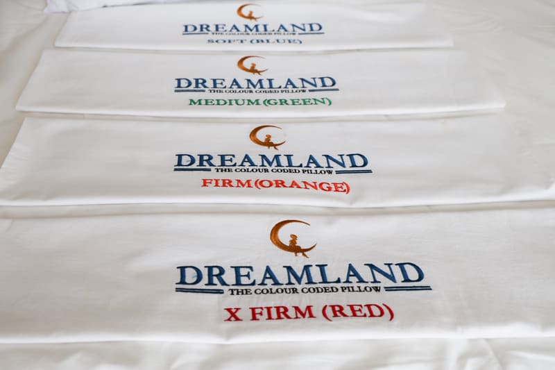 Close-up of the four embroidered Dreamland labels: Soft (Blue), Medium (Green), Firm (Orange) and X Firm (Red)