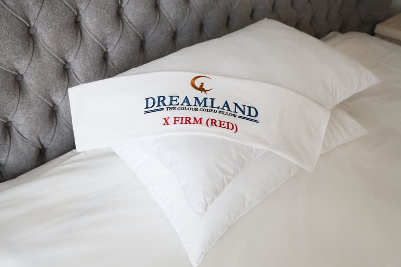 Extra Firm pillow folded to show its red embroidered label